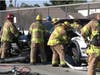 Firefighters work to rescue trapped victims in traffic collision