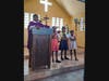 The parish priest and children at St. Anne's Parish in Haiti.