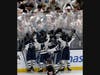 The Eagle’s hockey team celebrates with their vibrantly enthusiastic fan section through the poly-glass.