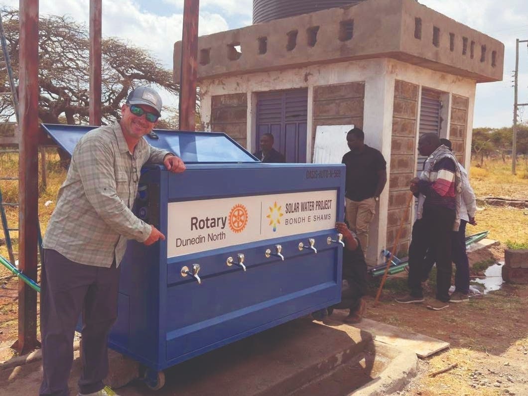 District Governor Mark Middleton helps unpack and install the Oasis solar water filter in Kenya, which was made possible by the Rotary Club of Dunedin North.