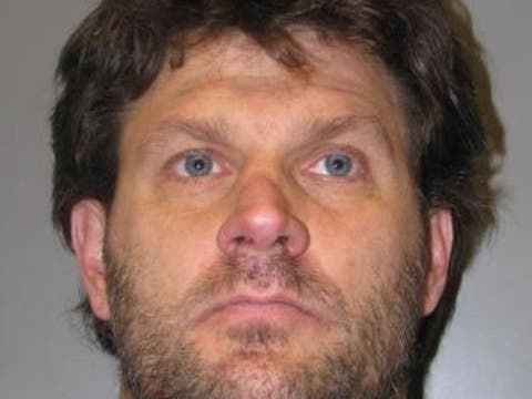 A Silver Spring man is accused of spying on a female neighbor as she undressed and walked around her home.