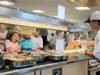 Flik Food Services Worker Yahaira Mendez helps New Canaan Country School students make their hot lunch selections.