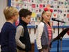Fourth grade assembly announcers Sam Peake of New Canaan, Wiley O'Connor of Darien and Fleur van Reesema of Rowayton