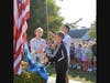 New Canaan Country school students Ava Dell'Aquila, Capone Andrade and Desmond Springer raise the school flag.
