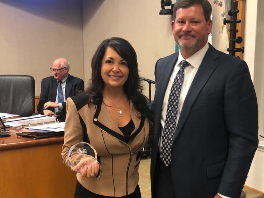 Assistant City Manager and Director of Public Works Shohreh Dupuis is presented with the 2019 Public Parking Program of the Year Award for the City's Smart Parking Guidance System