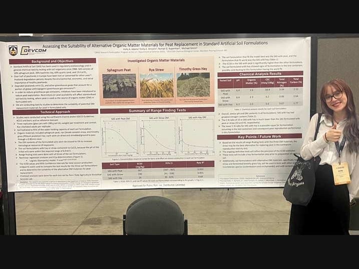 Holly Adams stands in front of her research poster.
