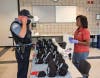 Artist Dorothy Straughter helps a police officer fit his new mask. 