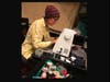 Artist Nicole Burns (Ni Bu) works on masks at her sewing machine. 