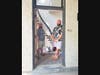 Ben Walker (left) and Joe Leamanczyk in the front entrance of the Charles S. Young House that they are restoring in Blue Island. Behind them is the grand spiral staircase, one of the few original features left in the house. 