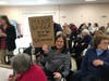 Linda Levitt held a sign in reaction to the proposed move of the Health Department into the Callahan Senior Center.