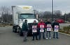 A group of strikers attempt to block a delivery truck in Natick.