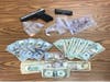 Several bags of drugs, a gun and over $8,000 in cash was confiscated by police.