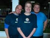 A photo of Mark Casey (center) with his brothers Greg (left) and Rob (right) during the first annual tournament.