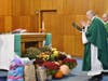 Father David Taurasi blesses the winter care kit and prayer shawl donations with the assistance of Deacon Ed Elibero.