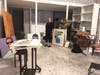 Carol Bruns stands with what is left of the artwork she is selling from her Dumbo loft.