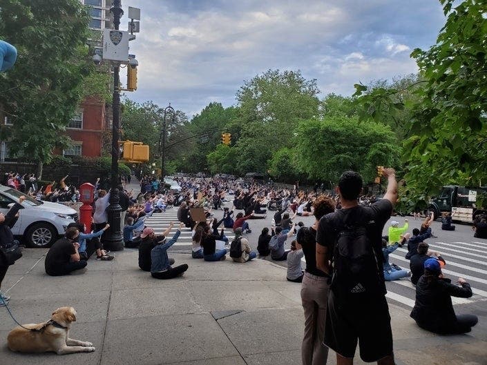 Protesters gather outside Gracie Mansion on Tuesday.