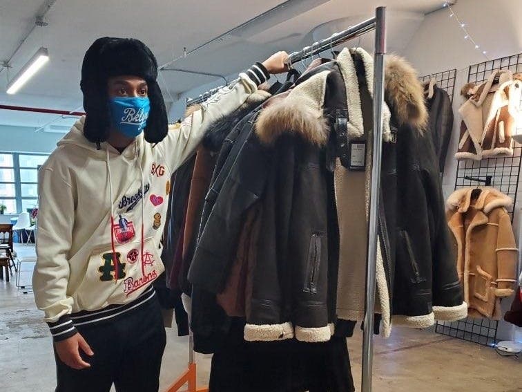 The socially distanced fashion show is the latest event at a holiday bazaar set up at Marcy Plaza.