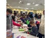 Scouts assembling warming bags for the Beth El Center in Milford