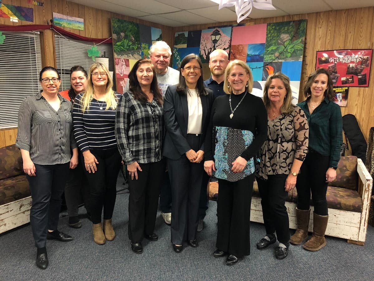 Laura Ahearn (pictured center) with NSYC Executive Director (center left), Board of Directors, and Staff.