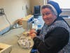 Sr. Kathleen Mary Coonan, ASCJ, principal of Sacred Heart Academy, sews a surgical cap for Yale New Haven Hospital.