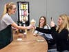 Hannah Ortell hands a coffee drink to Emily Smith as Catherine Schulte looks on.  Emily Smith was the cafe's first customer.