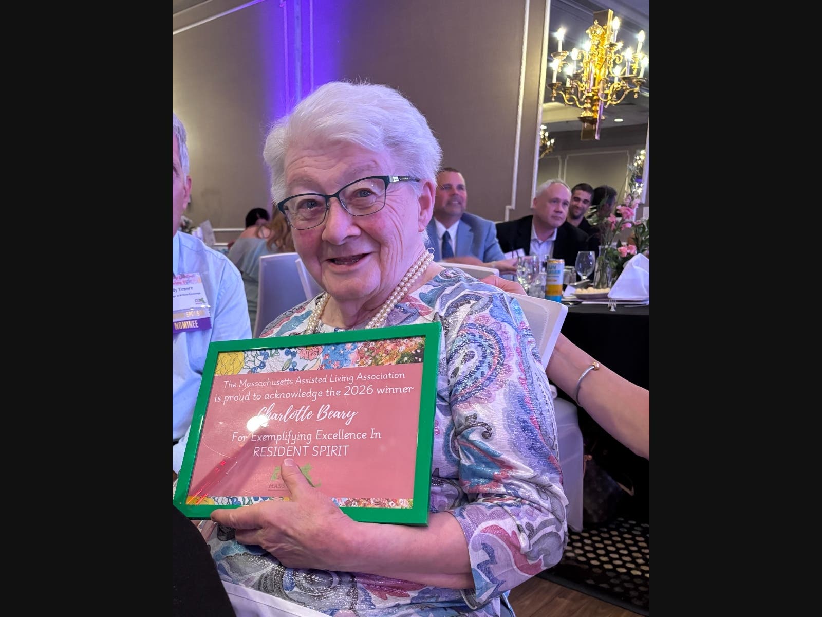 Charlotte Beary, resident at The Village at Willow Crossings, accepts the Mass-ALA Resident Spirit Award