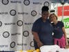 Church volunteer June Casella helps with booth setup.