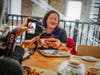 Cadry Nelson, who writes the Cadry's Kitchen blog, lines up a shot of Laura VanZandt, author of Bite-Sized Beet, while participants in an Oct. 11-13 blogger tour of McHenry County dine at Duke's Alehouse & Kitchen in Crystal Lake.