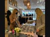 Singalila Gallery co-owner Carley Matyas shows off a hand-dyed scarf to shopper Casey Haan on a recent Tuesday afternoon. The shop hosts a diaper drive to benefit Keeping Families Covered Monday through Saturday, Nov. 8-13.