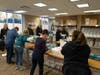Keeping Families Covered Founder/CEO Ann Marie Mathis (upper left) checks on Team Atturo as members participate in a VIP Wrappy Hour at the nonprofit's Waukegan facility. Atturo Tire Corp. is a Diamond-level Changing Table sponsor.