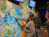 Jordan Burg talks about a world map on display in the Volo Museum's military history exhibit during a guided tour of the museum. The newly launched tour offering is available Tuesdays and Thursdays, included with museum admission. 