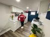 Dawn Bremer, president and owner of the Bremer Team - Keller Williams Success Realty, shows off the kitchenette of the team's new concierge suite — where home sellers can work or relax with kids and pets during showings or home inspections.