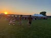 Event-goers pull a child on a wagon as the sun sets over McCullom Lake during Bands, Brews & BBQ in 2023. This year's event is Aug. 16-18 at Petersen Park, McHenry.