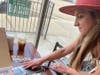 Artist Lauren Sharp of Johnsburg looks over pictures of her late mother, Adrienne Paradise, while discussing her business, Art for Adrienne, and her mental health advocacy during a recent meeting at Toast & Roast in McHenry.