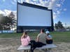 Becca Klutts hangs out with her daughter, Carrington, son, Asher, and family dog, Jetta, before the start of the films at the McHenry Outdoor Theater Friday, May 8. The theater will be open seven days a week starting Memorial Day weekend.