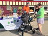 Payton and Taylor Gehm, along with 3-month-old Troy, chat with Jim Kearns of the Consumer Credit Counseling Service of Northern Illinois during a recent Project Popcorn night at the McHenry Outdoor Theater. 