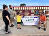 Jim Kearns of the Consumer Credit Counseling Service of Northern Illinois chats with Woodstock residents Megan and Ryan Redman and their son, Nicholas, during a Project Popcorn night at the McHenry Outdoor Theater.
