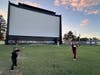 Dylan Gallardo and Hailey Koenig, both of Algonquin, play some catch before the movies start on a recent weeknight at the McHenry Outdoor Theater, where Major League Baseball will host an America250 event July 4.