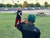 Dylan Gallardo readies his mitt after Hailey Koenig makes a throw before the movies start on a recent weeknight at the McHenry Outdoor Theater, where Major League Baseball plans an America250 event July 4.