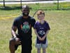 Ahman Green, all time leading rusher for the Green Bay Packers, with Sudbury's Patrick Glynn, gives NFL-style training to children grades K-8th at Red Zone's Train Like a Pro Skills Clinic.