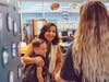 Teacher Julie Ramirez hugs second grader Jayce Jones as his mom Brooke Phillips (back to the camera) says good bye during the first day of classes at Central Elementary School.