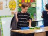 Second grader Jayce Jones checks out his new desk during the first day of classes at Central Elementary School. 
