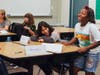 Khalia Satterwhite (right) shares a laugh with classmate Gabriela Brizuela on the first day of classes at Nicolet Middle School. Aryana Tacchia and Janessa Diaz are seated nearby.