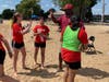 Waukegan Mayor Sam Cunningham high-fives an Heart of the City Elite athlete 