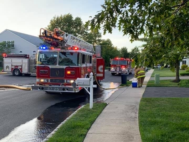 The neighbor kept the Barnegat fire at bay with a garden hose, officials said.
