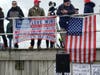 Both supporters and people who opposed President Donald Trump held signs overlooking a protest.