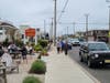 People sat outside of How You Brewin Coffee Company in Surf City, while others walked Long Beach Boulevard wearing masks.