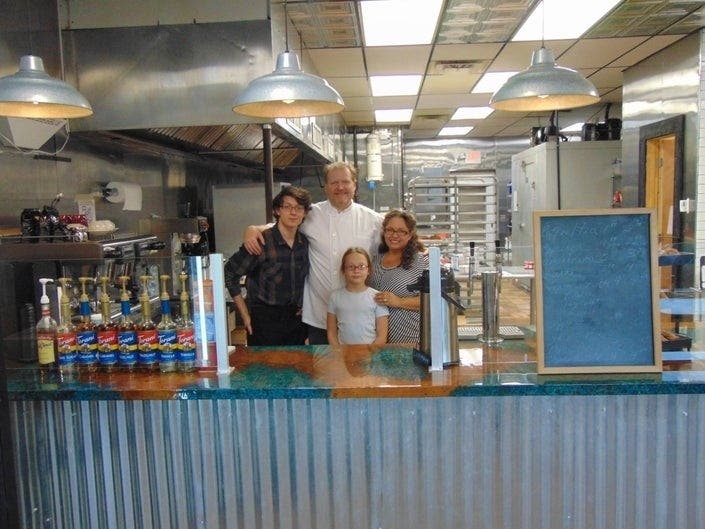 Owners Bill and Natercia Clanton posed with their children as they awaited the grand opening of Delights Artisan Café.