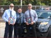Police Chief Michael C. DiBella, middle, presented retirement plaques to Sgt. Robert Surtees and Lt. Vincent Meehan.