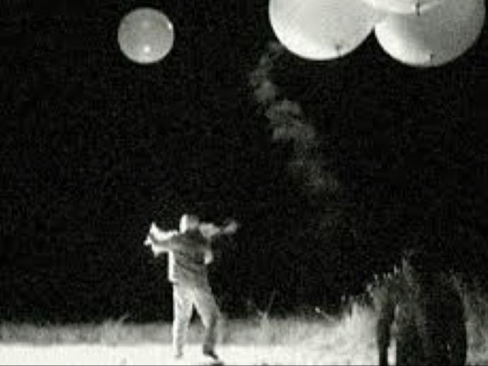 Joe Rudy releases a balloon while Chris Russo looks on. The duo architected the Morristown UFO hoax.